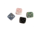 An aerial view of andean stone dice, set of four. Each dice is a different color: pink, blue, green, black