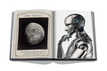 This is an image of the book opened up to two pages. The left page is a picture of the moon and the right page is a robot thinking.