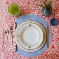 Cypress Coral Napkin displayed with matching tablecloth and tabletop place setting 