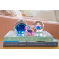 New Horizons large paperweight styled with coffee table books and other paperweights. 
