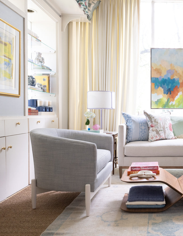 blue rounded chair with white legs