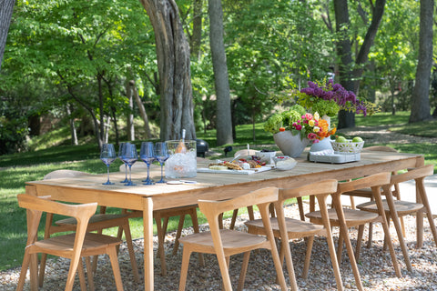 outdoor dining table and chairs in a backyard