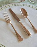 Christofle America Flatware dinner fork, knife, and spoon on placemat
