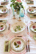 Full view of tablescape display with Italiano Bloom Deep Plate in Pink 
