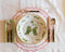Alternate view of Little Green Gardens Dinner Plate on top of placemat with flatware and napkin