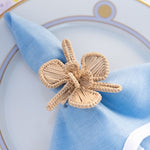 Woven Lily Napkin Ring on blue napkin on plate