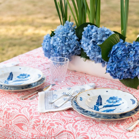 Starry Nights Deep Plate, Blue, styled in outdoor place setting with floral arrangment 