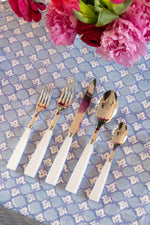 Full set of Sabre Paris Icone Flatware in White on top of tablecloth