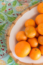 Juliska Classic Bamboo Natural Oval Platter displayed with fruit on top of tablecloth