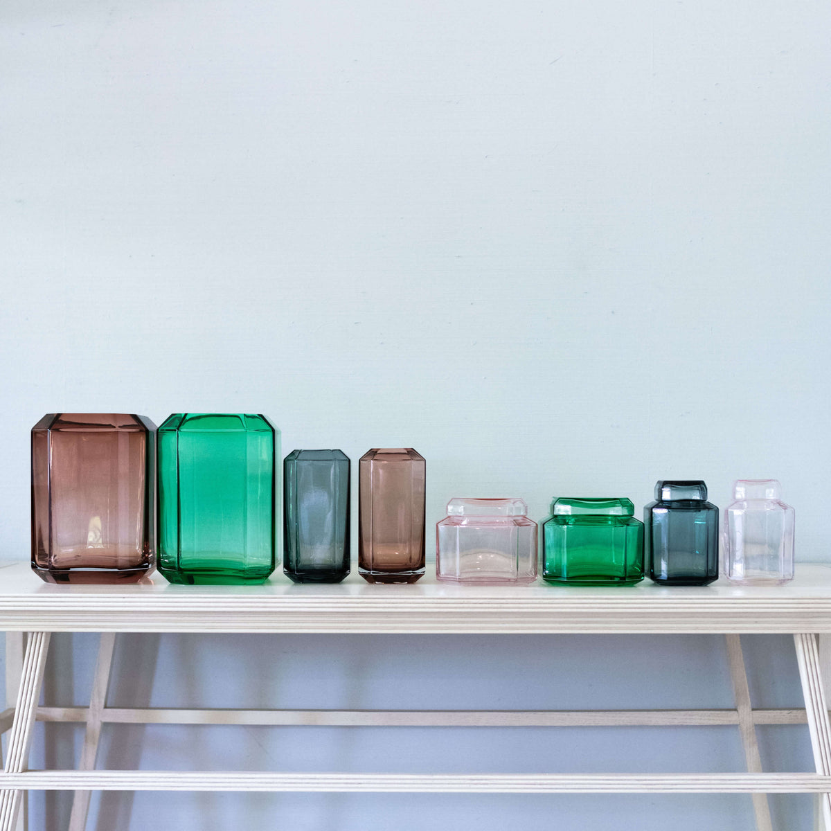 Blue Glass Box on table with other glass box in various sizes and colors