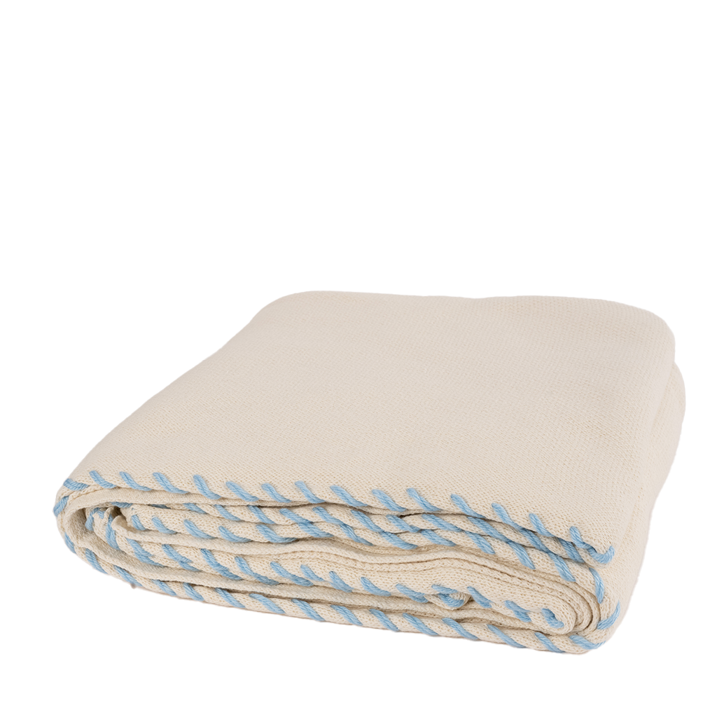 cream throw blanket with light blue stitching