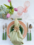Antibes Napkin, Celery with orchid napkin rings in place setting