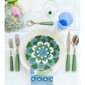 Indigo Thin Glass Octagonal Cup displayed with dessert plate, dinner plate, flatware and napkin on top of tablecloth