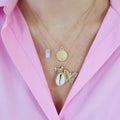 Small Round Locket on model with shell and butterfly charm