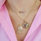 Upper Case Charm, A, styled on model with butterfly charm and pink bar necklace