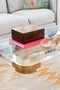Tinsley Acrylic Coffee Table in room with books and decor on top