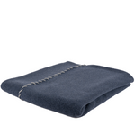 navy blue throw folded alternately 