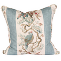 A cream pillow with two blue stripes on the side. Branches with greenery and a blue bird perched on the branch 