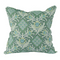 Green pillow with floral and diamond patterns 