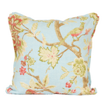 background robin egg blue with branches and muted floral. bird sitting on branch. front of pillow