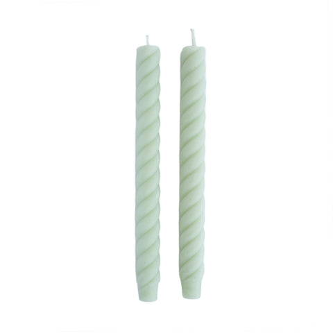 pair of swirled, light blue taper candles