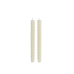 two off white swirled taper candles