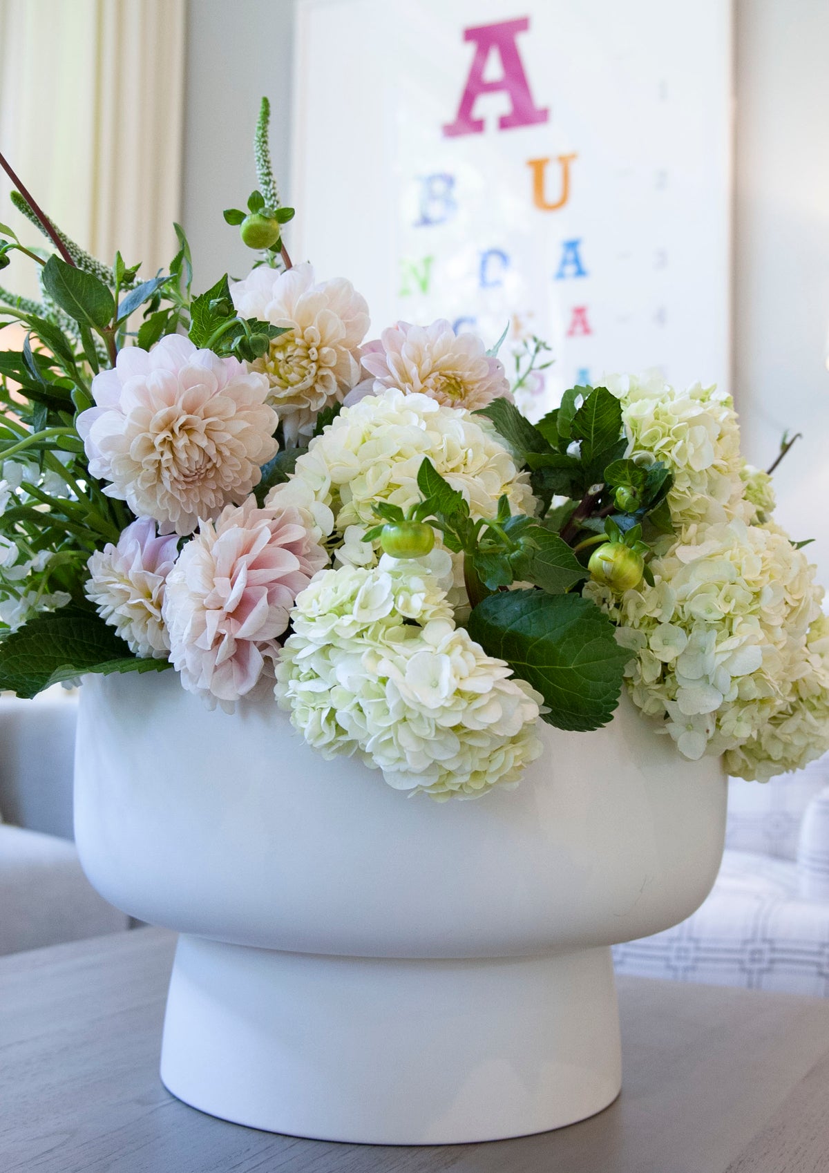 White Footed Bowl filled with flowers on coffee table