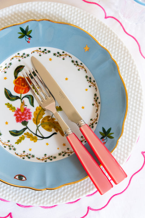 Sabre Paris Icone Flatware in Candy displayed on salad plate, dinner plate, charger and placemat