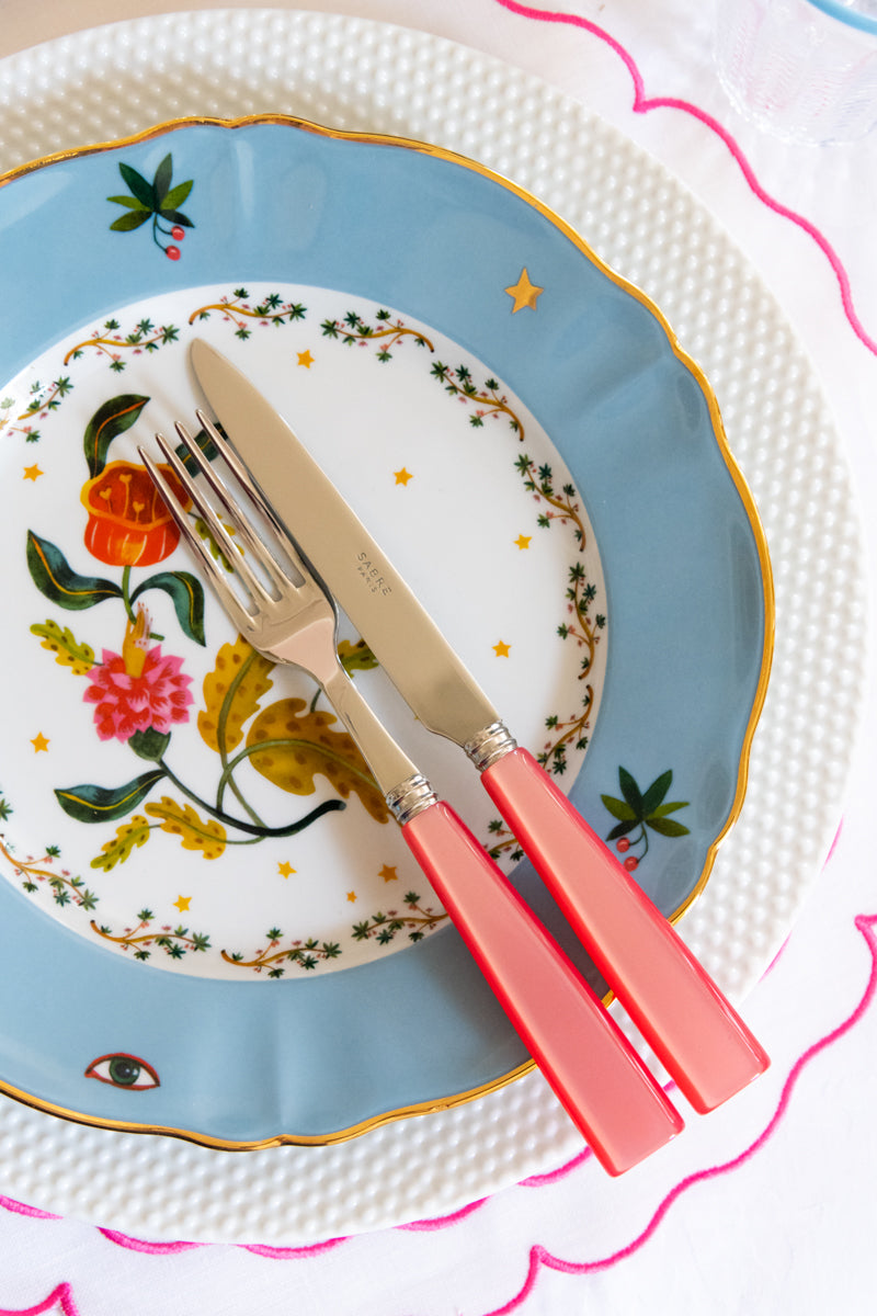 Raynaud Caviar Charger with dinner plate and flatware on top of placemat