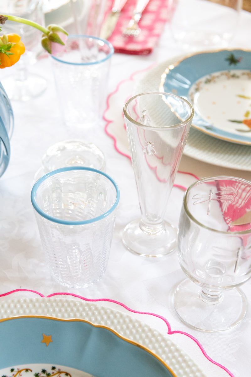 Hive Society Champagne Flute displayed on top of tablecloth with dinner setting and glassware