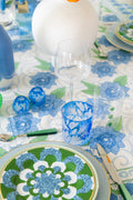 Three Tiered Green Embellishment Tumbler styled on table cloth next to blue and white detailed cup, and wine glass
