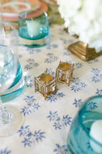 Close up view of L'Objet New York Diner Salt & Pepper Set in Gold on top of tablecloth