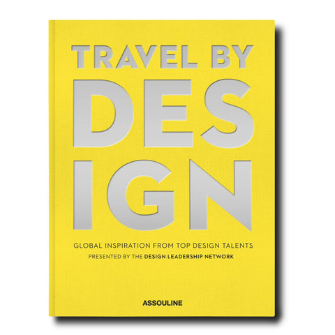 Yellow book with large silver letters spelling "travel by Design"