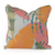 Colorful pillow with orange and pink leaves and greenery with blue accents. 
